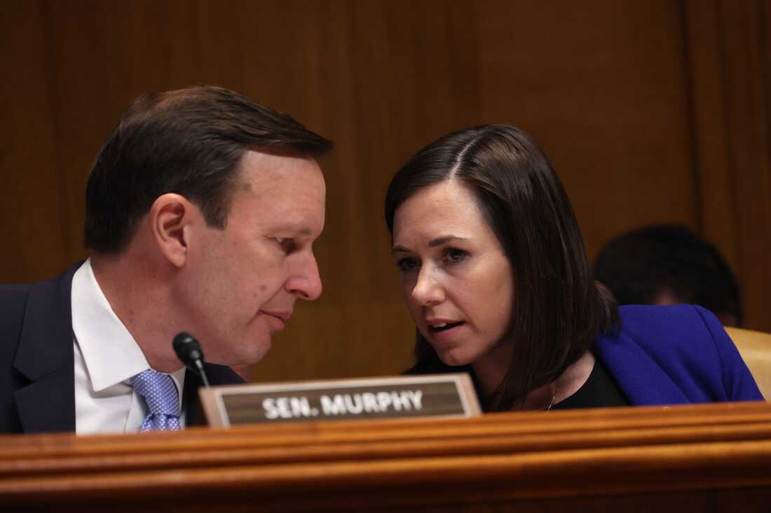 康涅狄格州民主党参议员克里斯·墨菲 (Chris Murphy) 在 2023 年 3 月 29 日在国会山举行的听证会上与阿拉巴马州共和党参议员凯蒂·布里特 (Katie Britt) 交谈。